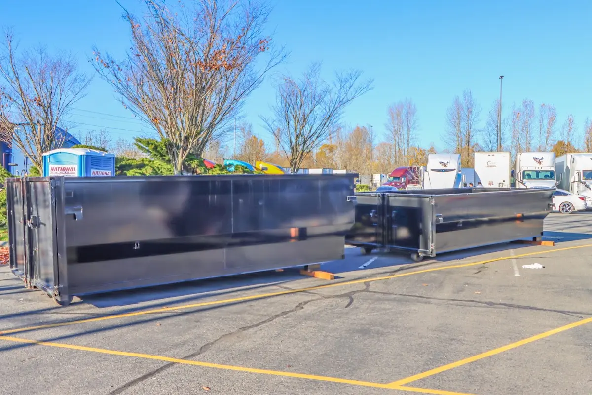 Professional dumpster rental service with roll-off container on residential driveway in Olean